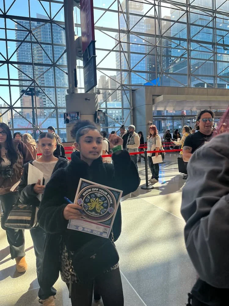 Wide view of National Portfolio Day at the Javits Center with students meeting college representatives