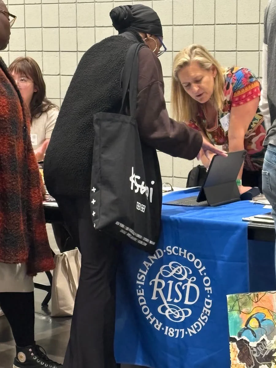 RISD booth at National Portfolio Day with school signage and students waiting for portfolio reviews